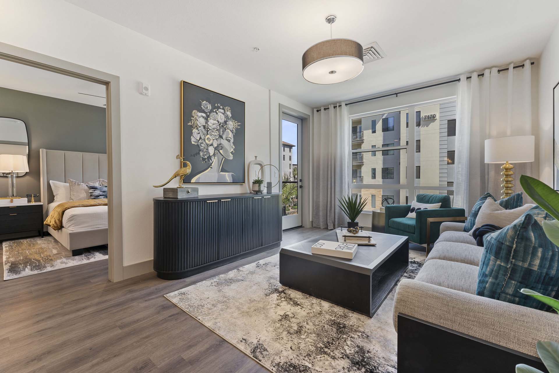 Model living room at Soltra Kierland apartments for rent in Scottsdale, AZ, featuring wood grain floor paneling.